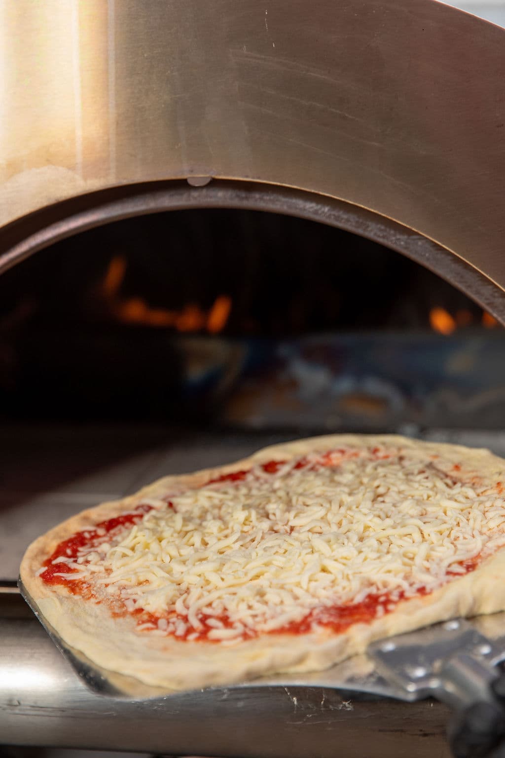 A slice of wood-fired pizza ready to serve