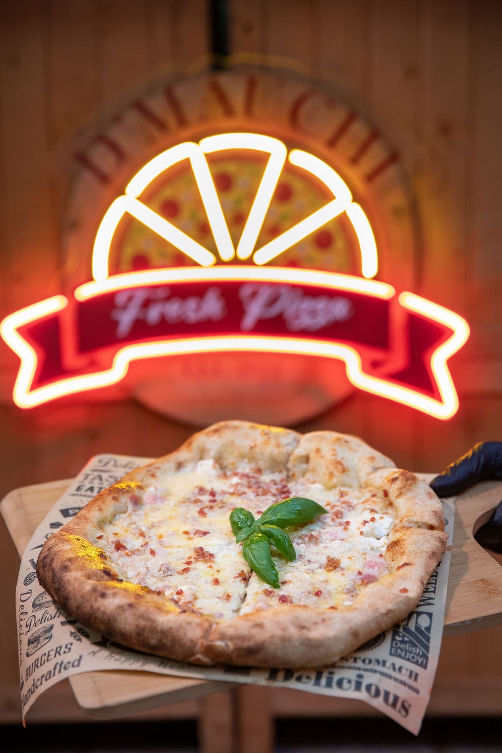Wood-fired pizza served live at a Miami event